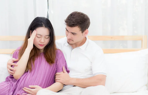 Pregnant asian woman belly acheand feel sick and husband with ta — Stock Photo, Image