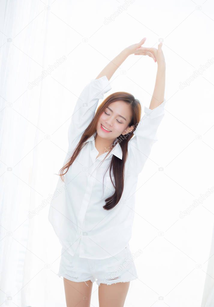 Beautiful young asian woman stretch and relax standing in bed af