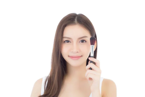 Beauty asian woman applying make up with brush of cheek isolated — Stock Photo, Image