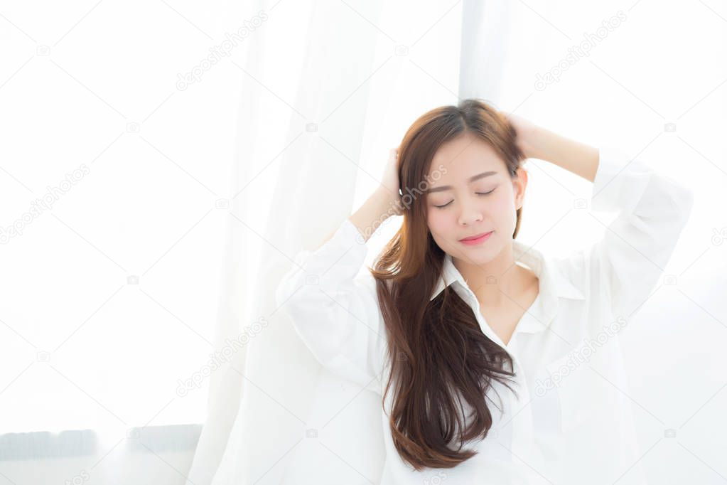Portrait of beautiful young asian woman standing the window and 