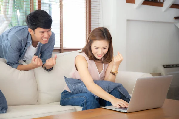 Beautiful portrait asian young couple working laptop with smile — Stock Photo, Image