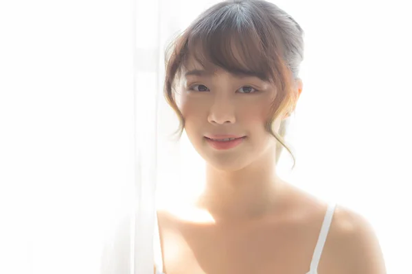 Retrato de hermosa joven asiática de pie la ventana y — Foto de Stock