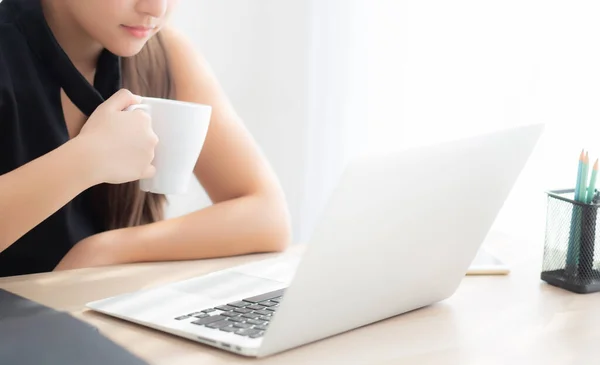 Mooie jonge freelance Aziatische vrouw glimlachend werken en op schoot — Stockfoto