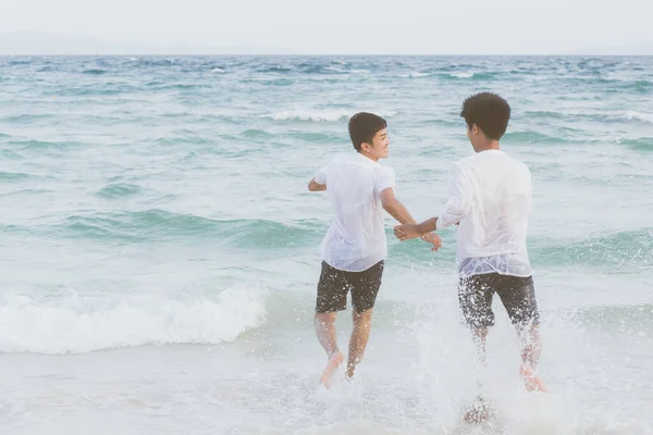 Homosexual portrait young asian couple running with cheerful tog — ストック写真