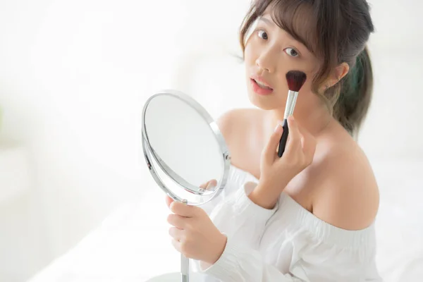 Beauty portrait young asian woman smile with face looking mirror