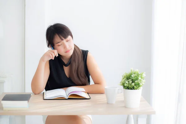 Beautiful asian woman writer smiling thinking idea and writing on notebook or diary with happy on desk office, lifestyle of asia girl is success, female planning working, education and business concept.