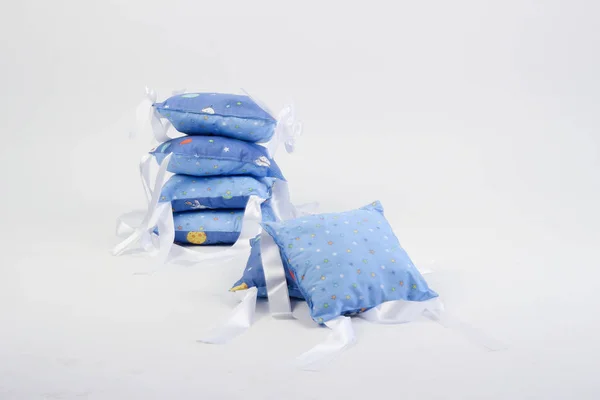 textiles for newborns in the photo Studio on a white background, the side of the pillow in a baby bed, blankets are transformed into envelopes for a walk, a cocoon for a comfortable and safe sleep of