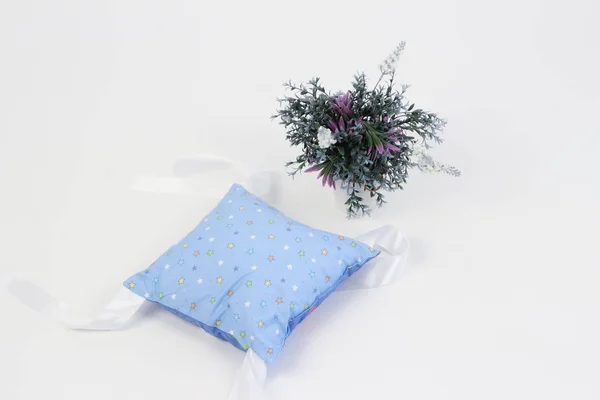 textiles for newborns in the photo Studio on a white background, the side of the pillow in a baby bed, blankets are transformed into envelopes for a walk, a cocoon for a comfortable and safe sleep of