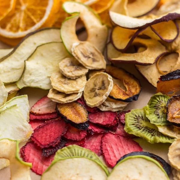 a variety of dried fruits, dried apples, dried tomatoes, dried plum, dried plums, dried kiwi, dried banana, dried oranges, dried pear, dried melon, fruit patty. Slices of fruit in various compositions and with sprigs of Christmas tree