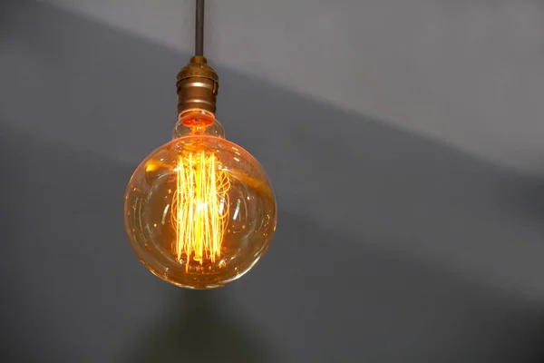 An orange circular lamp on a gray background