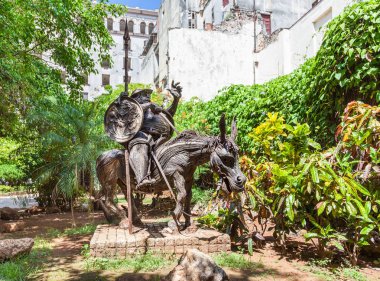 Cuba, Old Havana. Statue, made from metal, of character Sancho Panza on the donkey. Sancho Panza is a fictional character in the novel Don Quixote written by Spanish author. clipart