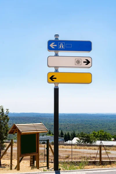 Reflective traffic signal with three direction indicator panels with blue sky. Indicator signal