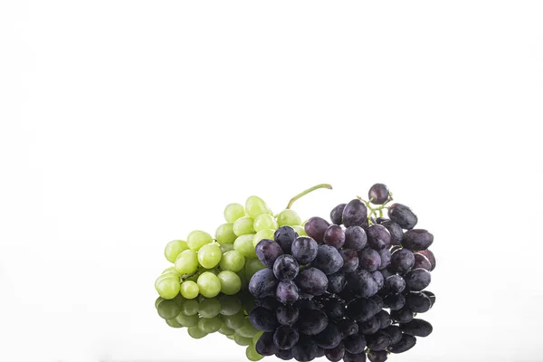Two bunches of green and black grapes on a white background. Fresh Isolated Grapes — Stock Photo, Image
