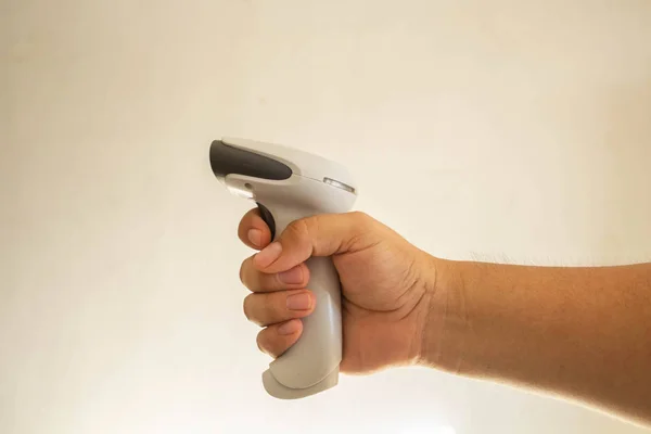 hand taking manual barcode scanner