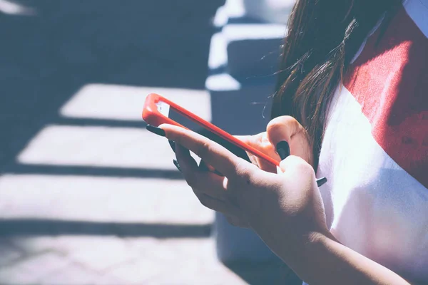 Cep telefonunu kullanan bir kıza yaklaş.