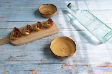 Kristal tekila şişesinin üst görüntüsü veya jicaras ve baharatlı portakallı mezcal