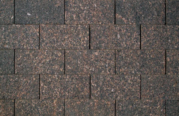 Stone Granite tiles or bricks. Red granite. Tile texture.