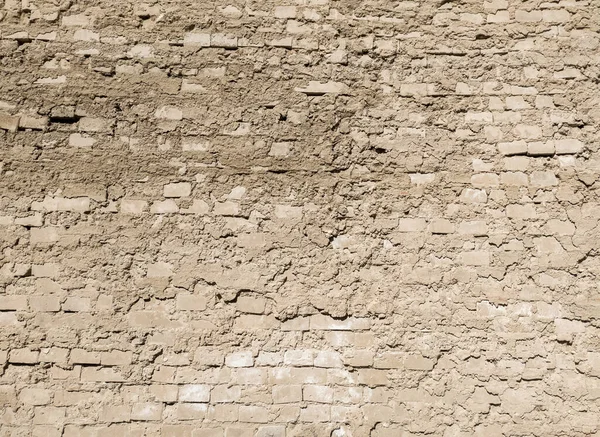 Eski yıpranmış tuğla bir duvar. Alçı duvardan düşüyordu..