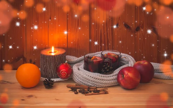 Glasses of mulled wine wrapped in scarf and candle — Stock Photo, Image
