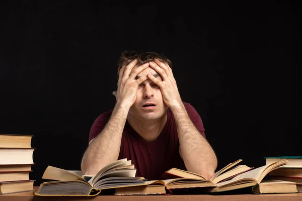 Joven Estudiante Masculino Sienta Escritorio Con Libros Fondo Una Pared — Foto de Stock