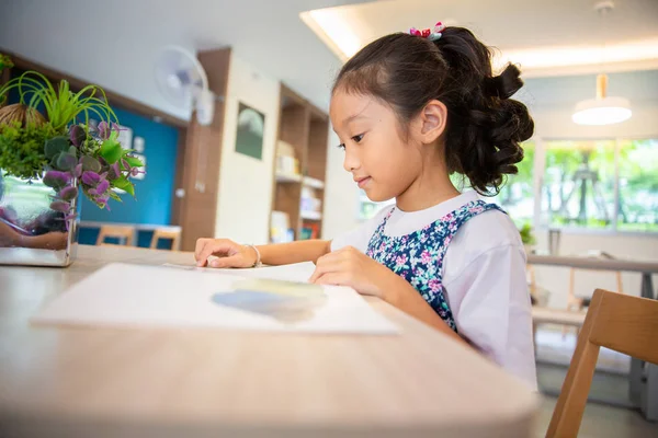 在学校图书馆室读书的小女孩 — 图库照片