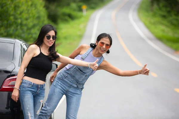 two traveler girls asking help on the road
