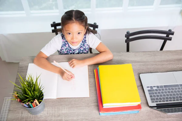 Primary school girl reading and writing book , top view — Stock Photo, Image