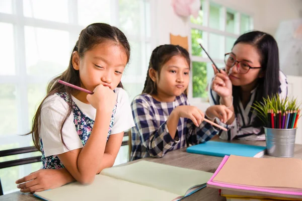 Young students girls feel sad and boring with strict teacher war