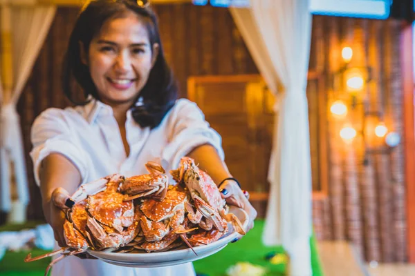 Großaufnahme gegrillte Krabben auf dem Teller einer Touristin. Gruppe von bis — Stockfoto