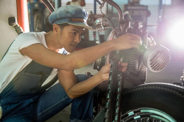 Mechanical technician man maintenance and repair motorbike at workshop