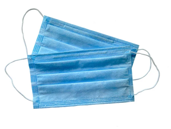 Mavi tıbbi maske beyaz arka planda izole edildi. Tıp ve sağlık kavramı..