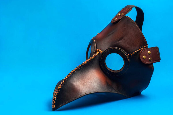 Plague doctor mask isolated on a blue background. medical face shield. pandemic concept
