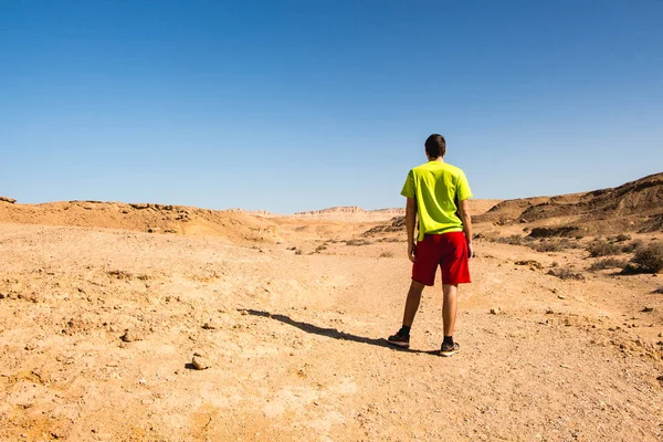 Traveler man is the Negev desert. beautiful desert landscape and concept of freedom and happiness, heathy