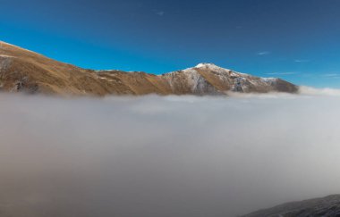 Taze karla kaplı güneşli dağ tepeleri.