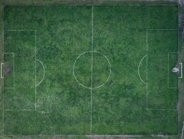 Old, dirty Football field, top view. Flat lay