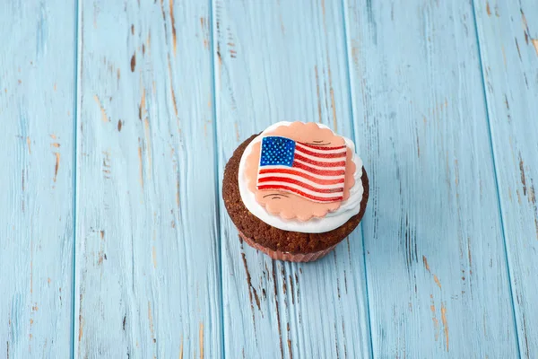 American cupcake on a blue table, close up