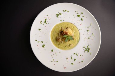 Siyah bir zemin üzerine bir tabak içinde taze çorba