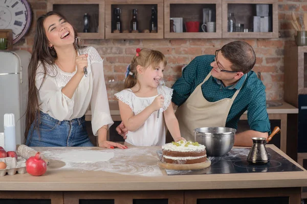 Happy family singing in the kitchen after cooking dinner