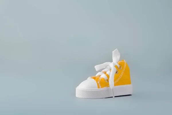 Yellow gym shoe on blue background