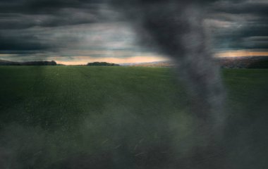 Tornado in a field at sunset of the day. Close-up. clipart