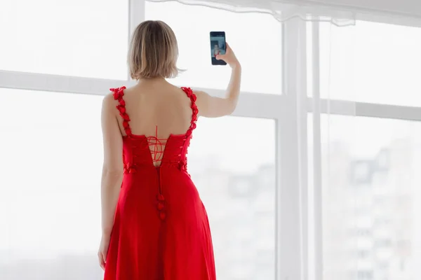 Mulher Vestido Vermelho Faz Selfie Smartphone — Fotografia de Stock