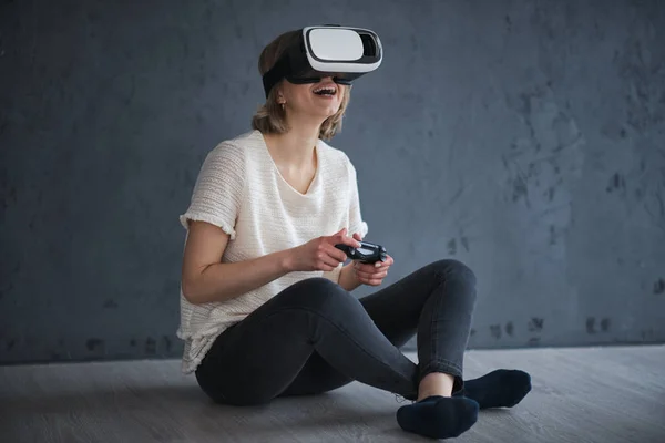 Young woman plays games with virtual reality