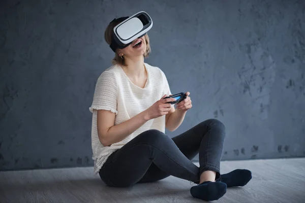 Beautiful girl plays games with virtual reality