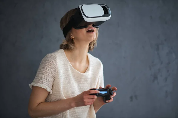 Beautiful young woman playing games with virtual reality