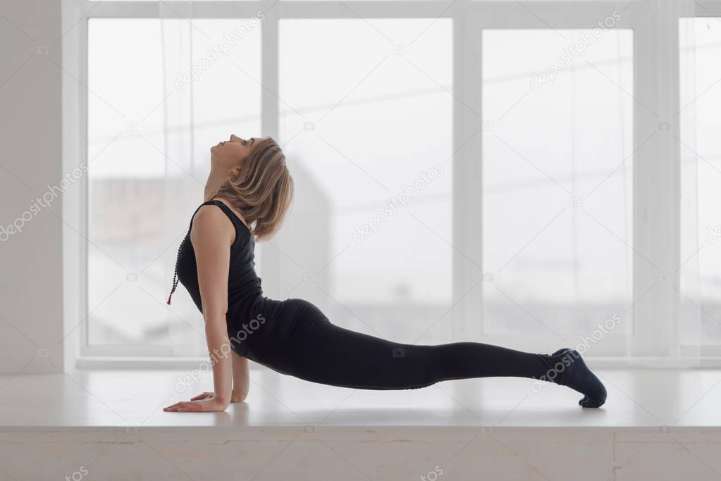 Beautiful woman in the hall practicing yoga