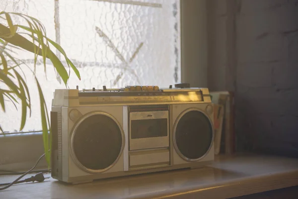 Vintage radio and tape recorder on the window