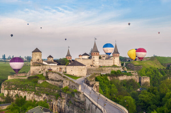 Medieval stone fortress in Kamenets-Podilsky and hot air balloons