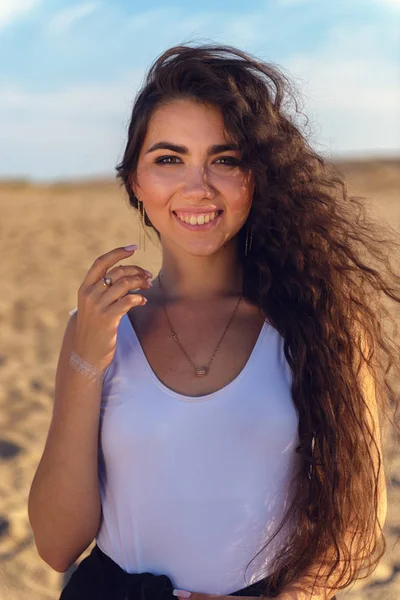 Young brunette woman in the desert on a hot day