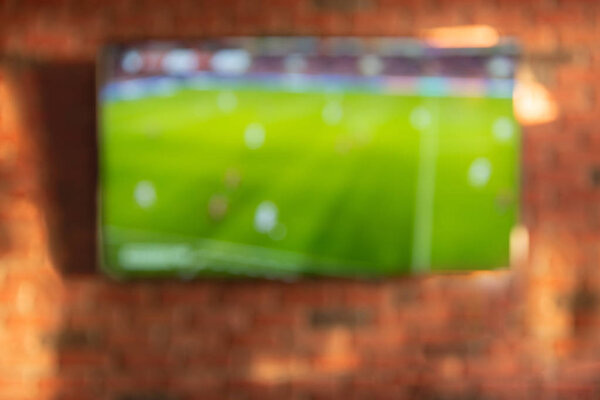 Football on tv - blurred background