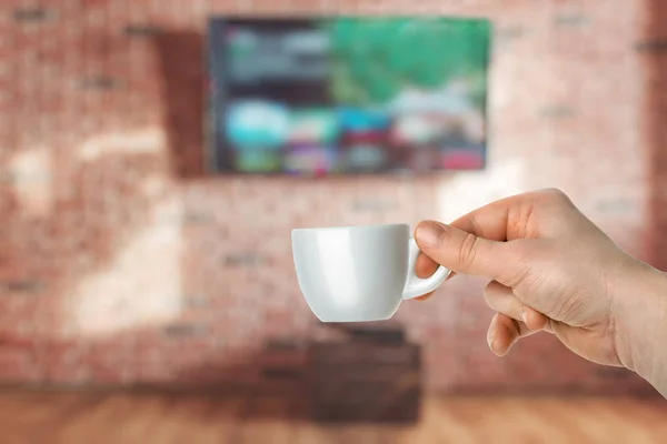 man with Cup of coffee and watching tv